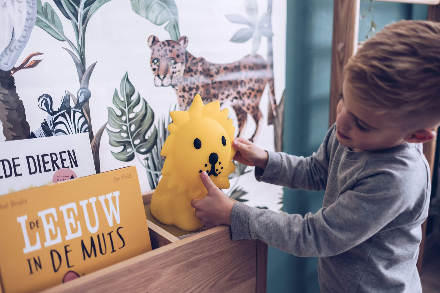 Child holding Lion First Light wireless night lamp