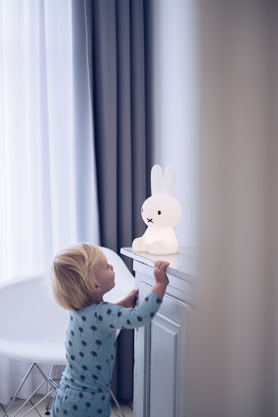 Child playing with Miffy First Light rechargeable night light