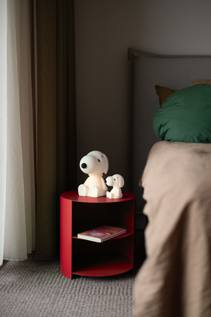 Snoopy Bundle of Light glowing softly on a bedside table