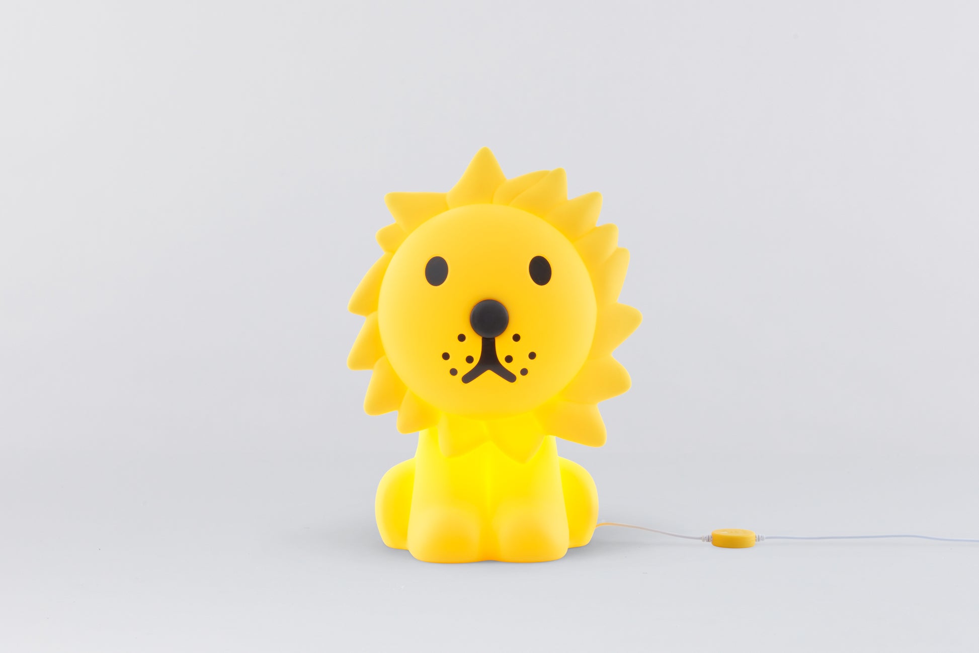 Yellow lion-shaped toy on a light gray background