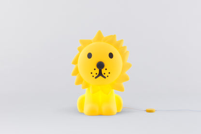 Yellow lion-shaped toy on a light gray background