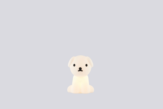 Small white dog figurine on a light gray background